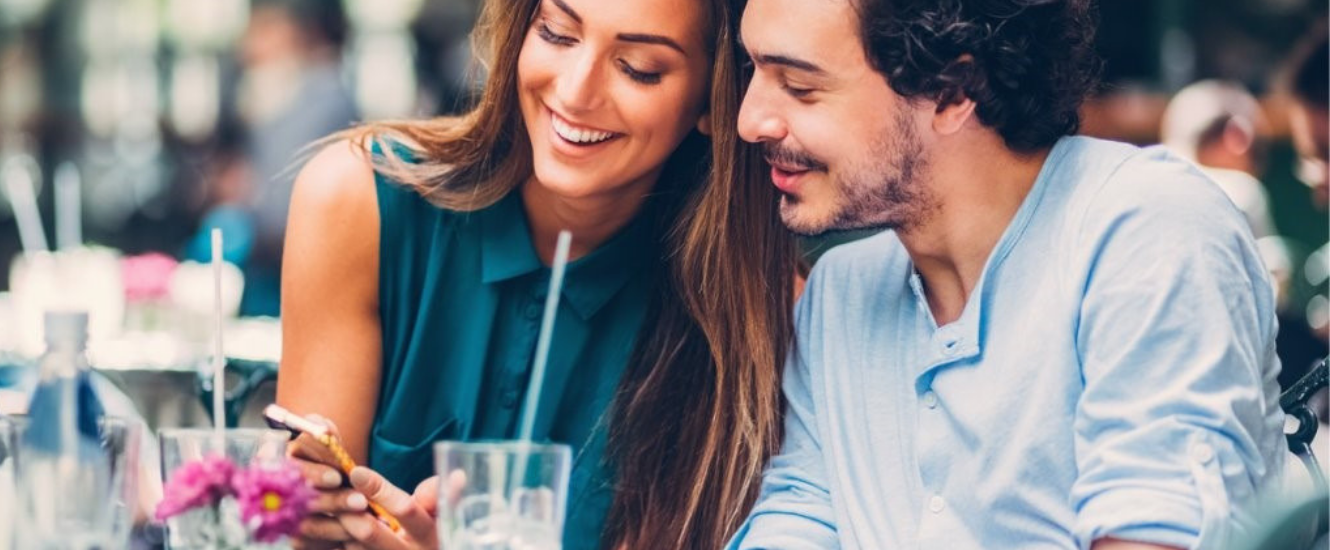 Couple looking together at mobile phone